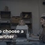 Work meeting around a table, with people talking and listening